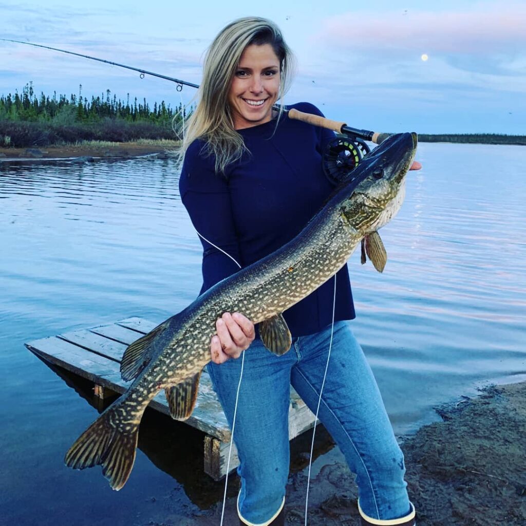 Katie Jo holding up a large pike