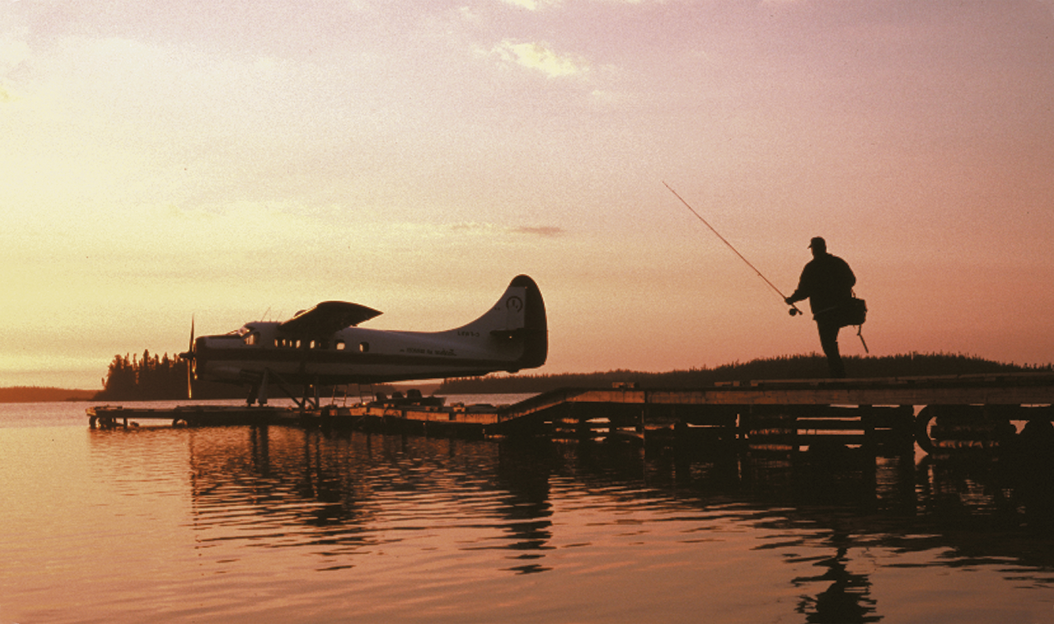 Man with fishing pole walking to Gangler's floatplane